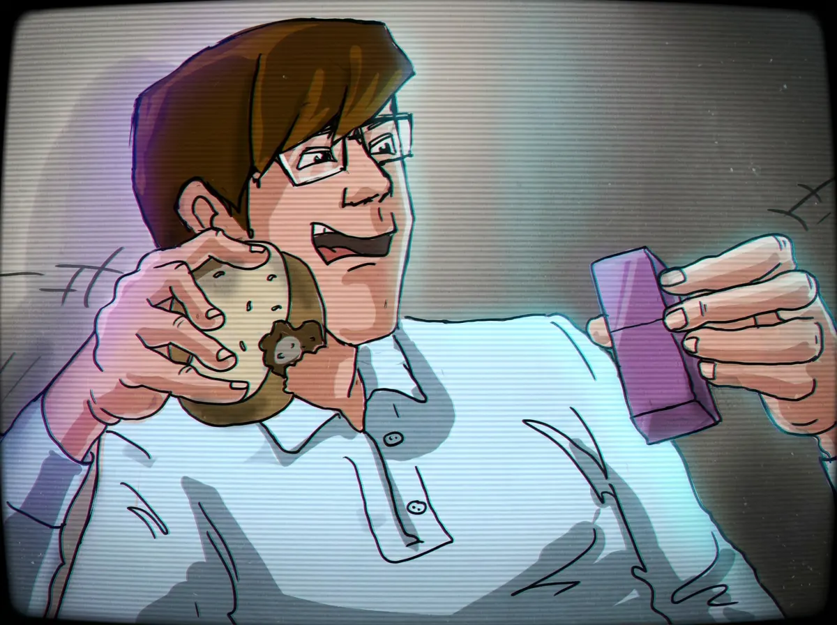 Alan McMillan grinning, holding a stale donut and a stick of purple gum at his desk